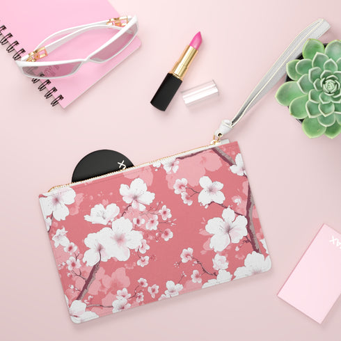 Pink cherry blossom clutch bag with seamless soft tones pattern.