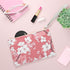 Pink cherry blossom clutch bag with seamless soft tones pattern.