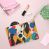 Modern abstract bright pattern clutch featuring bold colors for a statement accessory.