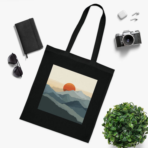 Minimalist black cotton tote bag with mountain peak design.