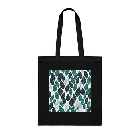 Stylish black cotton tote bag with repeating fern leaf pattern.
