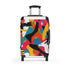 Bright geometric suitcase set in black with bold abstract pattern.