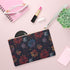 Vibrant festive clutch bag with colorful bursts of joy pattern.
