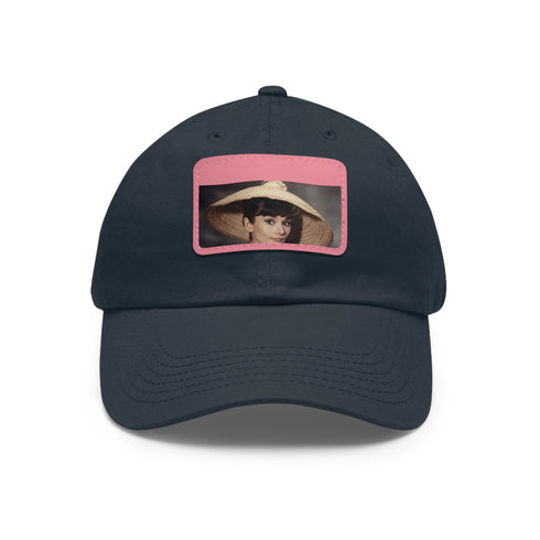 Audrey Hepburn monochrome baseball cap with light brown patch.