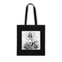 Coastal cotton tote bag with black lighthouse design for adventures.