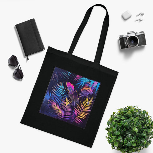 Vibrant black cotton tote bag with neon tropical leaf design.