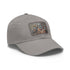 Steampunk gear-adorned white baseball cap with light brown patch.