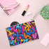 Neon urban graffiti clutch bag with bright colors, made in the USA.