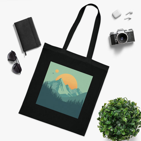 Black cotton tote bag featuring serene mountain landscape design.