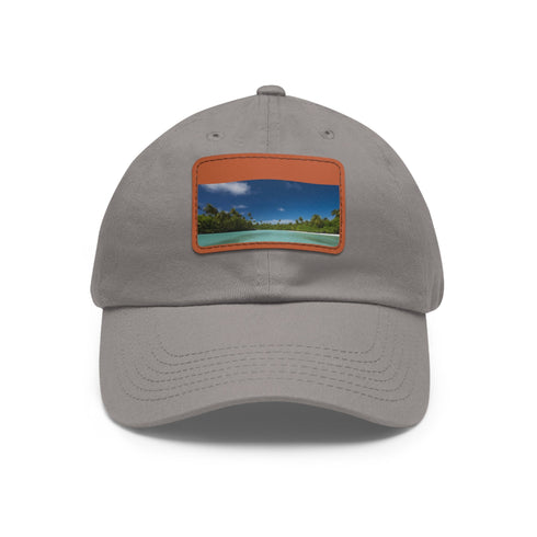 White cotton baseball cap with light brown patch, Aitutaki Paradise.