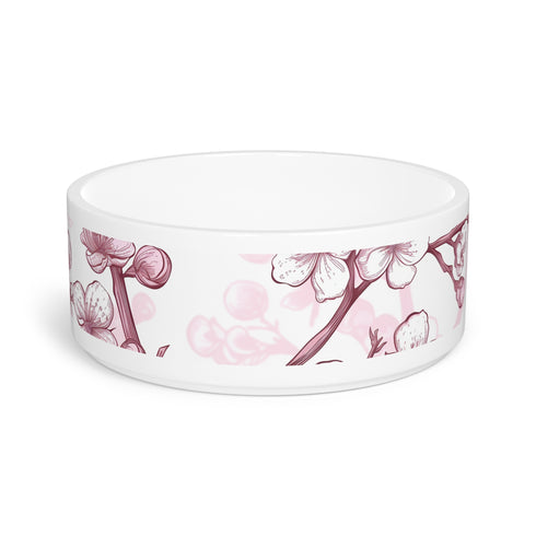 Pink and white ceramic pet bowl with cherry blossom pattern.