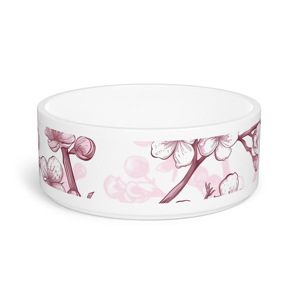 Pink and white ceramic pet bowl with cherry blossom pattern.
