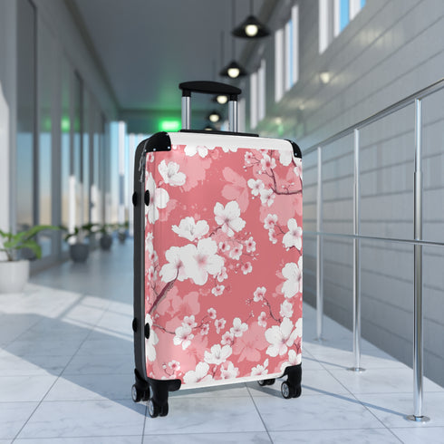 Small black cherry blossom suitcase for stylish travel enthusiasts.