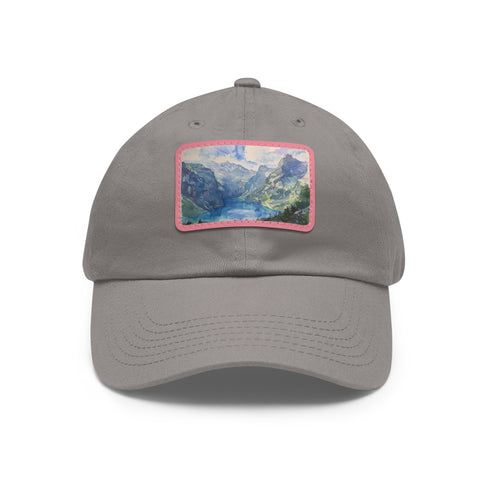 Swiss Alps watercolor baseball cap, white with light brown patch.