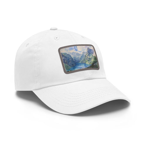 Swiss Alps watercolor baseball cap in white with light brown patch.