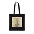 Black cotton tote bag with hand-drawn lighthouse against crashing waves.