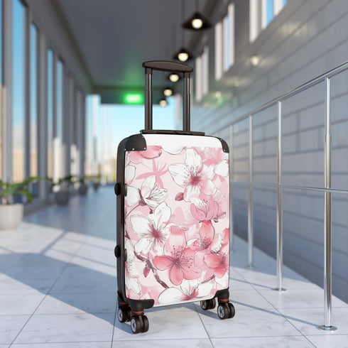 Elegant black small suitcase with cherry blossom seamless pattern design.