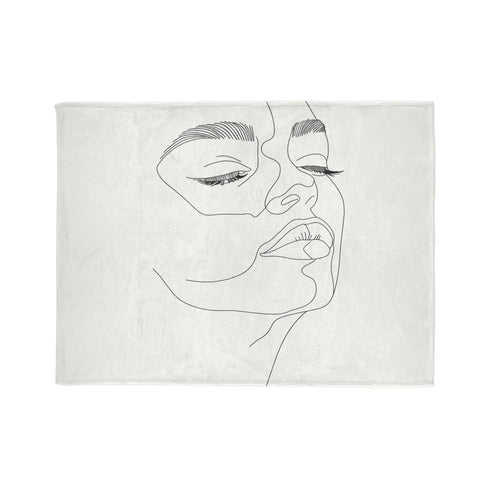 Luxurious face line art blanket, minimalist design for modern rooms.