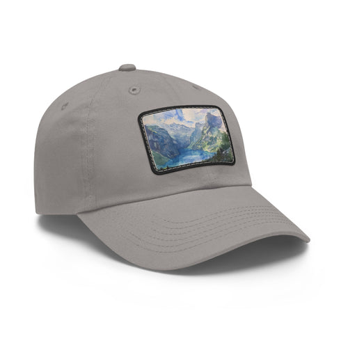 Swiss Alps watercolor baseball cap, white with light brown patch.