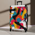Abstract bright geometric suitcase set with bold pattern in black.