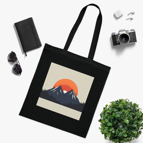 Minimalist black cotton tote bag with Alpine mountain sunrise design.
