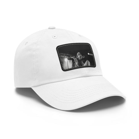White Dua Lipa singing snapback hat with light brown patch.