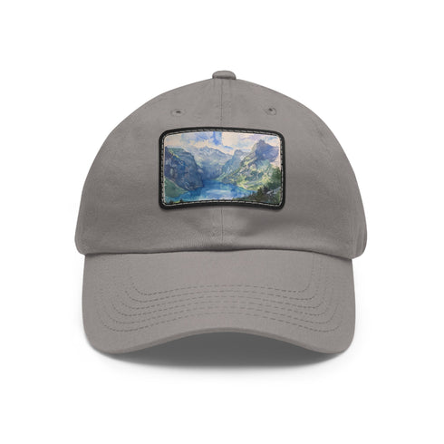 Swiss Alps watercolor baseball cap, white with light brown patch.