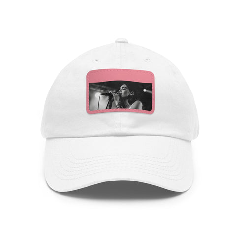 Stylish white snapback hat with light brown patch worn by Dua Lipa.