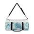 Eye-catching blue water duffel with all over print watercolor eyes pattern.
