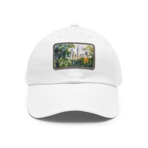 Central Park skyline watercolor baseball cap in white with light brown patch.