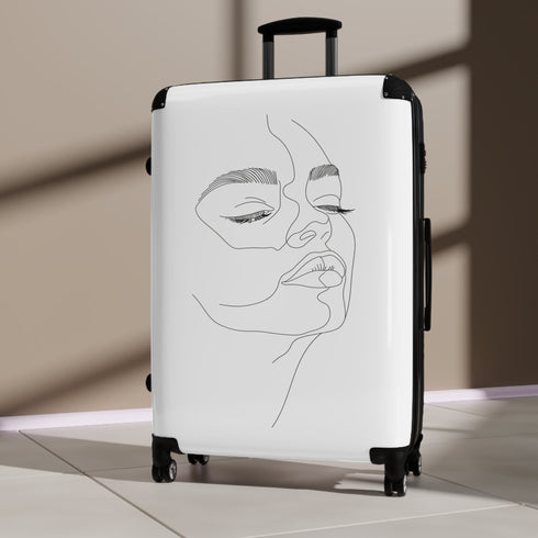 Chic minimalist face-inspired small black suitcase for stylish travel.
