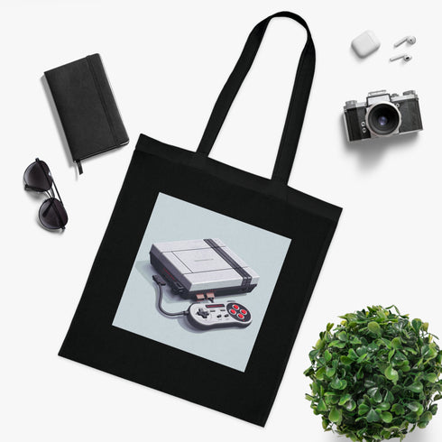 Black cotton tote bag with retro gaming console and pixel art design.