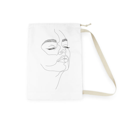 Minimalist abstract face laundry bag in all-over print for laundry organization.