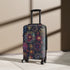 Vibrant small black travel suitcase with festive fireworks pattern.