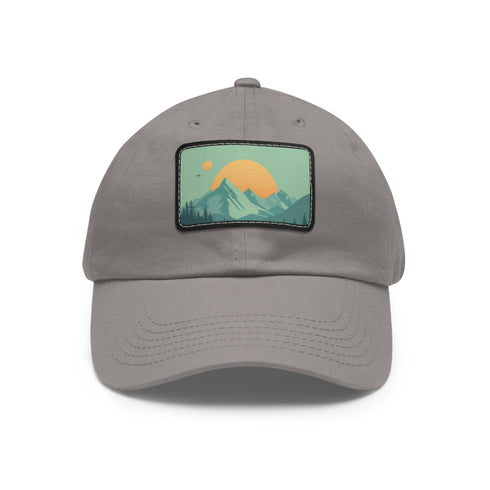 Minimalist white baseball cap with light brown patch showcasing mountain landscape.