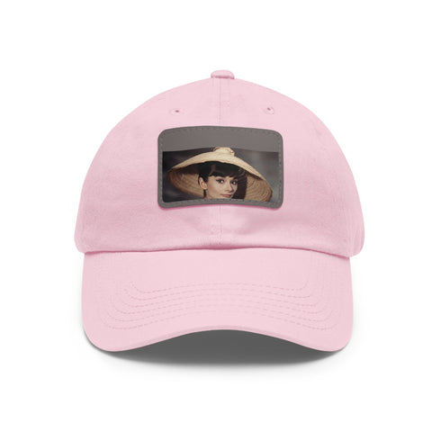 Iconic Audrey Hepburn monochrome baseball cap with light brown patch.
