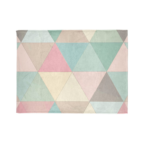 Pastel geometric pattern cozy blanket for restful sleep.
