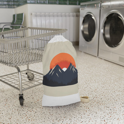 "Sunrise Mountain Laundry Bag - Minimalist design with rising sun over peaks, keep laundry organized in style"