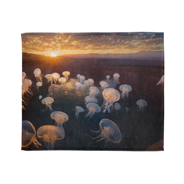 Sunset Canyon with Floating Bioluminescent Jellyfish — Plush Fleece Throw Blanket — Draped Over Sofa & Bed Lifestyle View