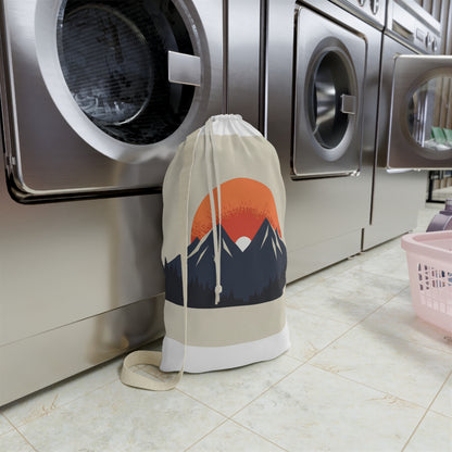 "Sunrise Mountain Laundry Bag: Organize laundry in style with minimalist mountain range design and rising sun over peaks"