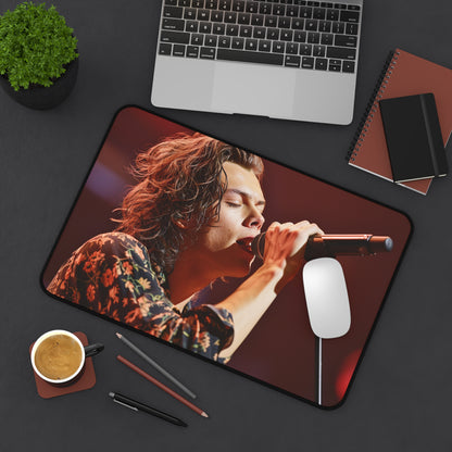 "Harry Styles Singing Desk Mat - Bring concert vibes to your workspace with this vibrant illustration of Harry Styles performing on stage. Surf on his music wave!"