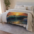 Golden Sunset Through Rolling Ocean Wave — 50×60 Plush Throw Blanket — Draped Over Sofa & Bed Lifestyle View